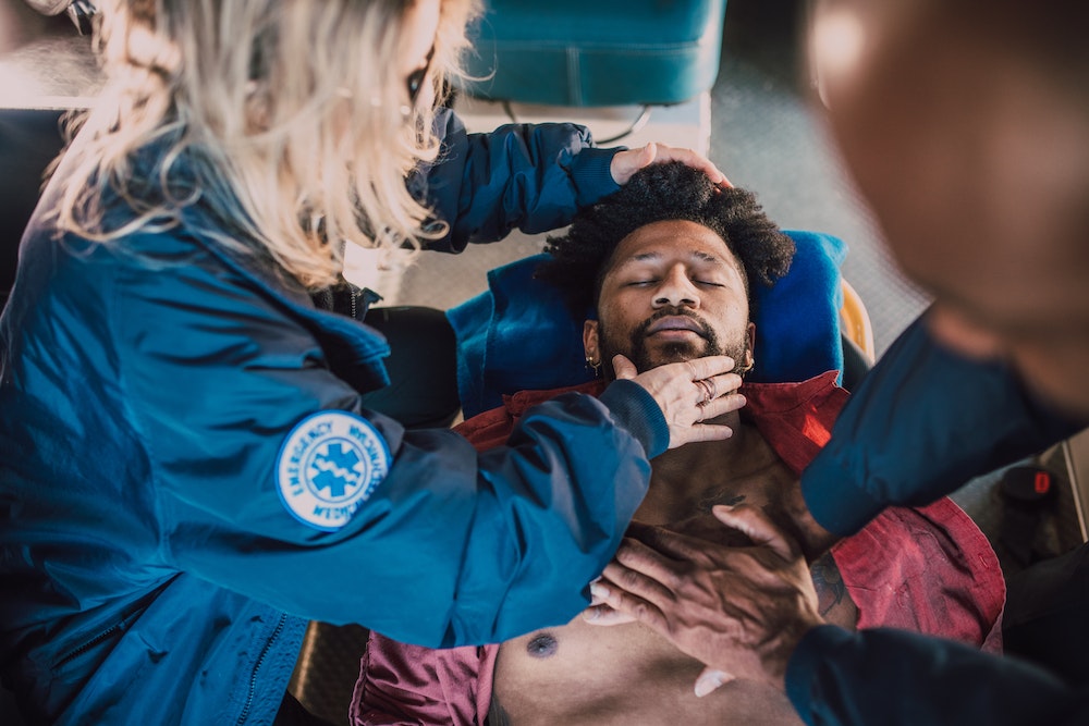 Image of a person performing CPR on a causality during an emergency